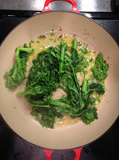 The traditional way to cook Cima di Rapa is to boil till tender; while the cima is cooking, sautee garlic and red pepper flakes in olive oil in a frying pan. When the garlic is soft and fragrant, remove the cima from the water with tongs, let some of the water drip off, and then toss it in with the garlic to "jump" it. (Careful! It may splatter!) Sautee for a few minutes, stirring to coat the cima.